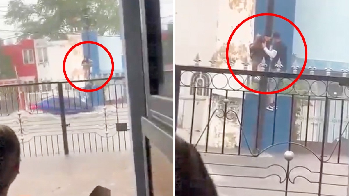 VIDEO Chofer y peatón se aferran a un poste para evitar que la lluvia los arrastre