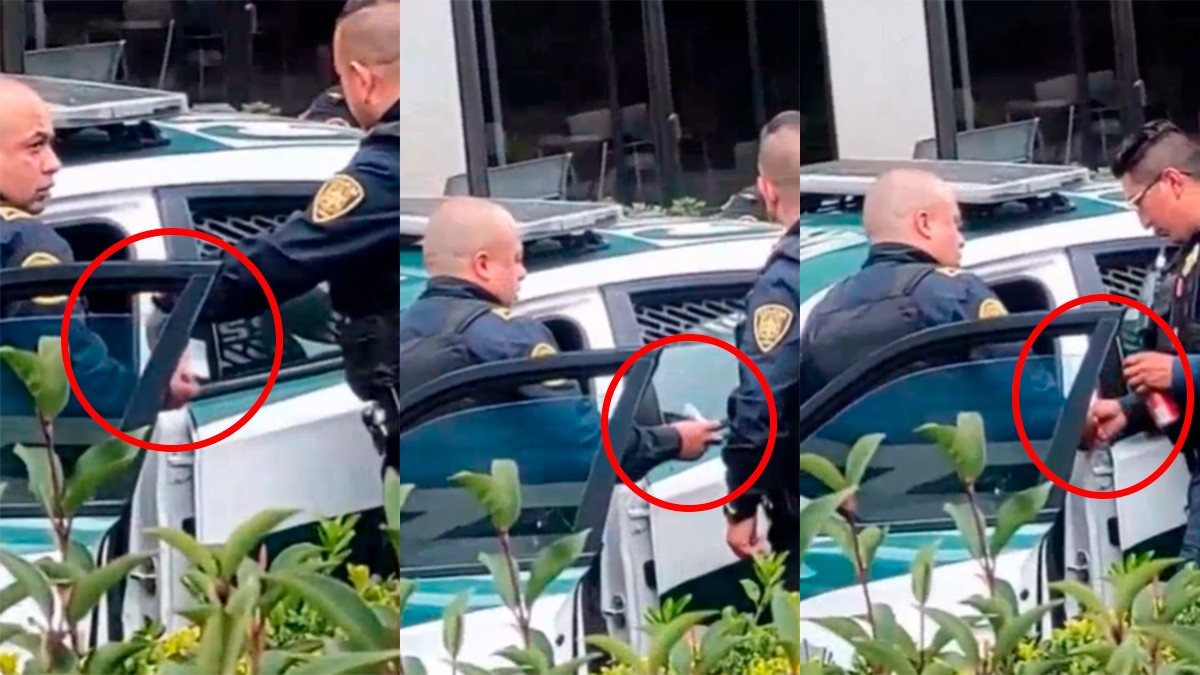 VIDEO Captan a policías dividiendo fajos de dinero en plena vía pública